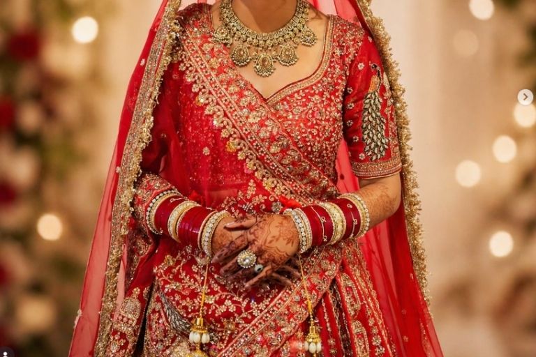 Bridal wear showcased with intricate gold embroidery.