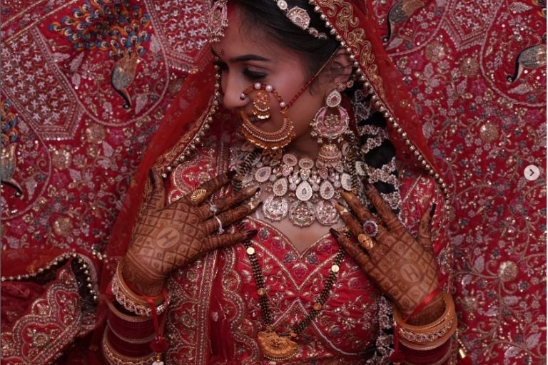 Bride dressed in designer bridal wear for wedding day.